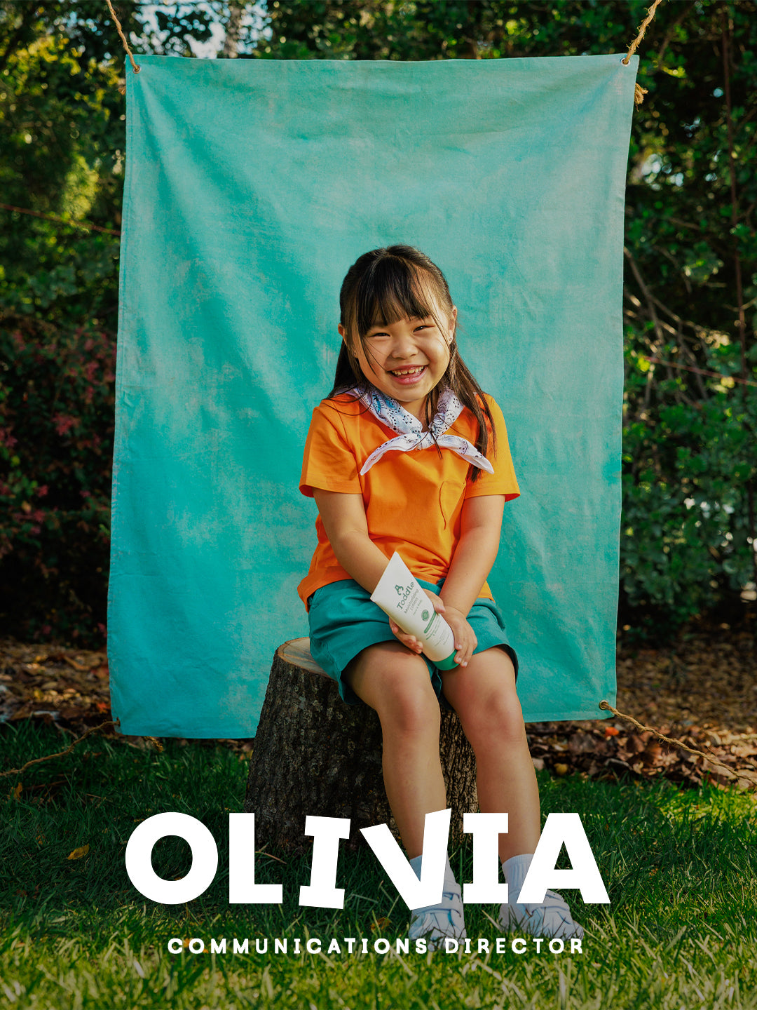 Olivia holding Toddle Skincare moisturizer lotion — gentle hydration for toddlers